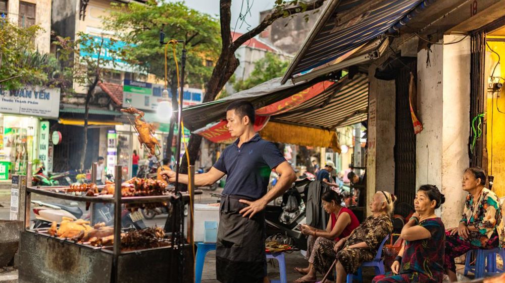 On déguste, au ras du trottoir, beaucoup de légumes, de porc au caramel, de poulets grillés, de nems… © J.-P. Fretillet